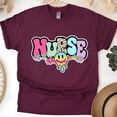 thumbnail image 1 of Nurse Graphic T-Shirt with Retro Pastel Letters and Smiley Design, Maroon, Size L, 1 of 6