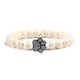 thumbnail image 1 of Pulsera con dije de huella de pata de piedra volcánica de lava negra mate natural, ideal como recuerdo para mascotas, amantes de los gatos y los perros., 1 of 2