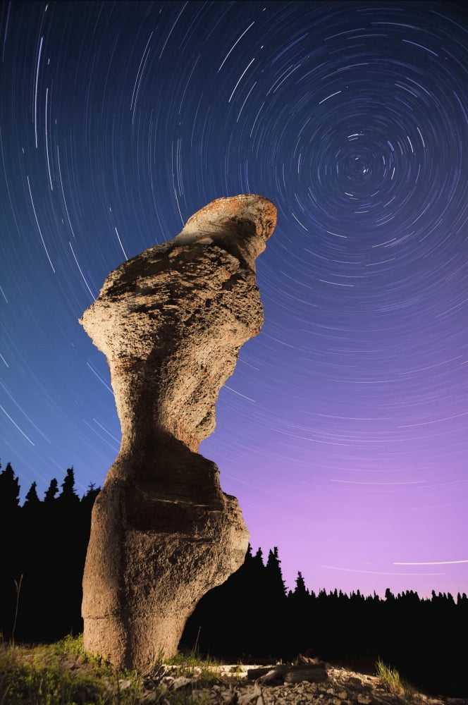Light painting on monolith and star trails Anse des Bonnes Femmes at Ile Niapiskau Mingan Archipelago National Park Reserve of Canada Cote-Nord Duplessis region Quebec Canada Canvas Art - Yves Marcoux