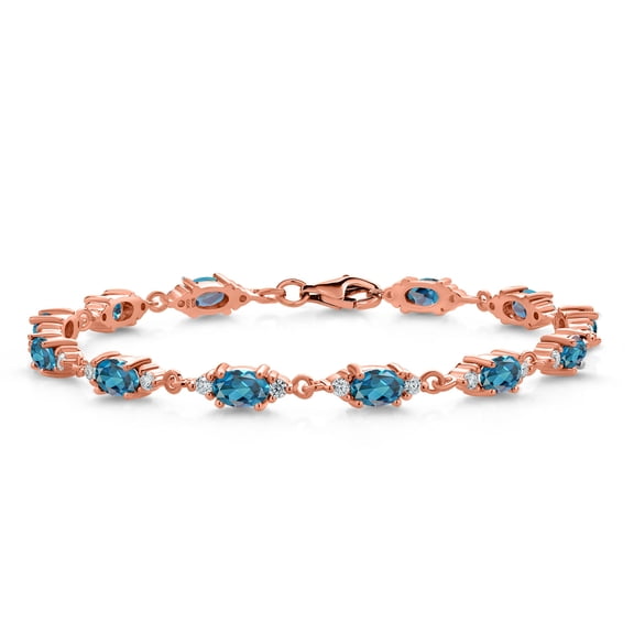Gem Stone King 18K Rose Gold Plated Silver London Blue Topaz and White Moissanite Tennis Bracelet for Women (8.11 Cttw, Gemstone Birthstone, Oval 6X4MM, 7.5 inch)