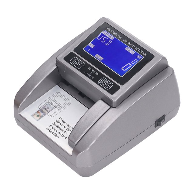 máquina contadora de dinero por denominación jadeshay modelo mg03 vista frontal en ángulo 3/4 con carcasa ABS gris y pantalla LCD azul que muestra conteo; panel superior con botones para modos (conteo, suma, lote, manual), amplia ranura de alimentación y salida frontal para billetes; indicada para bancos, tiendas y supermercados; velocidad 120 hojas/min y detección IR, MG, UV y MT. También suele usarse para prácticas educativas en formación de cajeros.