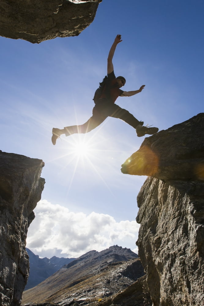 Backlit View Of Hiker Leaping Between Rocks Near Noatak River In The Brooks Range Gates Of The Arctic National Park Northwestern Alaska Above The Arctic Circle Arctic Alaska Summer Canvas Art - Scott