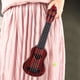 thumbnail image 4 of Juguete para tocar con cuatro cuerdas (44cm, marrón) de mini guitarra de ukelele imitada para niños, con instrumentos musicales pequeños., 4 of 5