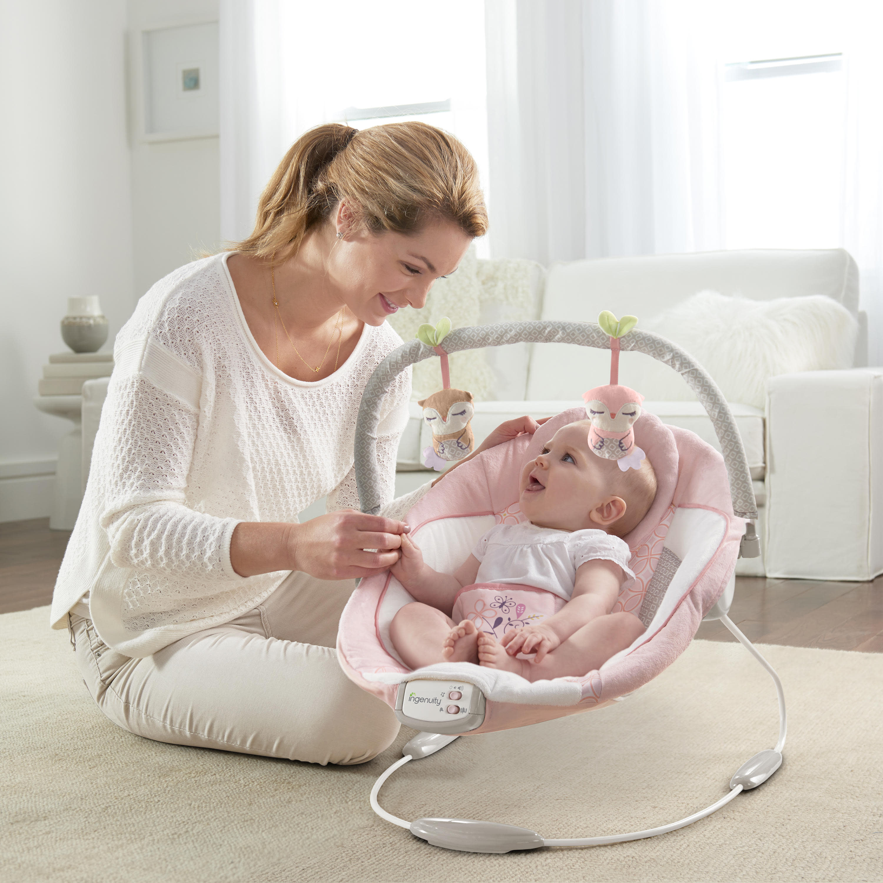 audrey cradling bouncer in pink