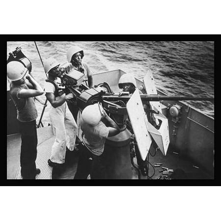 Gun Crew Stands - Five stewards mates stand at their battle stations as a gun crew aboard a Coast Guard-manned frigate in the southwest Pacific On call to general quarters these Coast Guardsmen man a20mm AA gun They ar