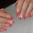 thumbnail image 1 of Punta francesa Press On Nails de color rojo almendra con lazo y perla, 1 of 6
