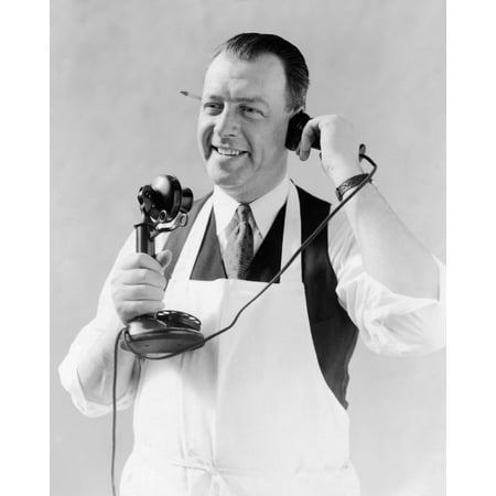 - 1920s Man In Apron Butcher Cook Talking On Candlestick Telephone Pencil In Ear Print By Vintage Collection