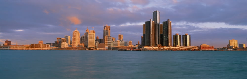 This is the skyline and Renaissance Center at sunrise It is a view of what they call the Motor City from Windsor Canada It shows the Detroit River in the foreground Canvas Art - Panoramic Images (27 x