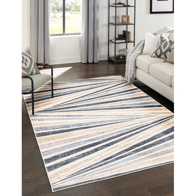 ECARPET Axel contemporary area rug featuring diagonal beige, blue, and gray stripes placed on dark hardwood floor in a bright living room with neutral furniture.