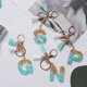 thumbnail image 3 of LLavero de 26 letras verdes de la A la Z para mujer, dijes de billetera, alfabeto inicial, dos colgantes de borla, llaveros de cadena, regalo de joyería, 3 of 4