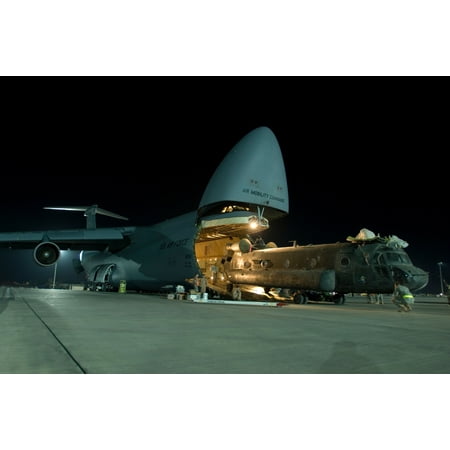 LAMINATED POSTER A C-5 Galaxy crew loads a CH-47D Chinook heavy lift helicopter into its cargo bay, Aug. 3, 2008. Joi Poster Print 24 x