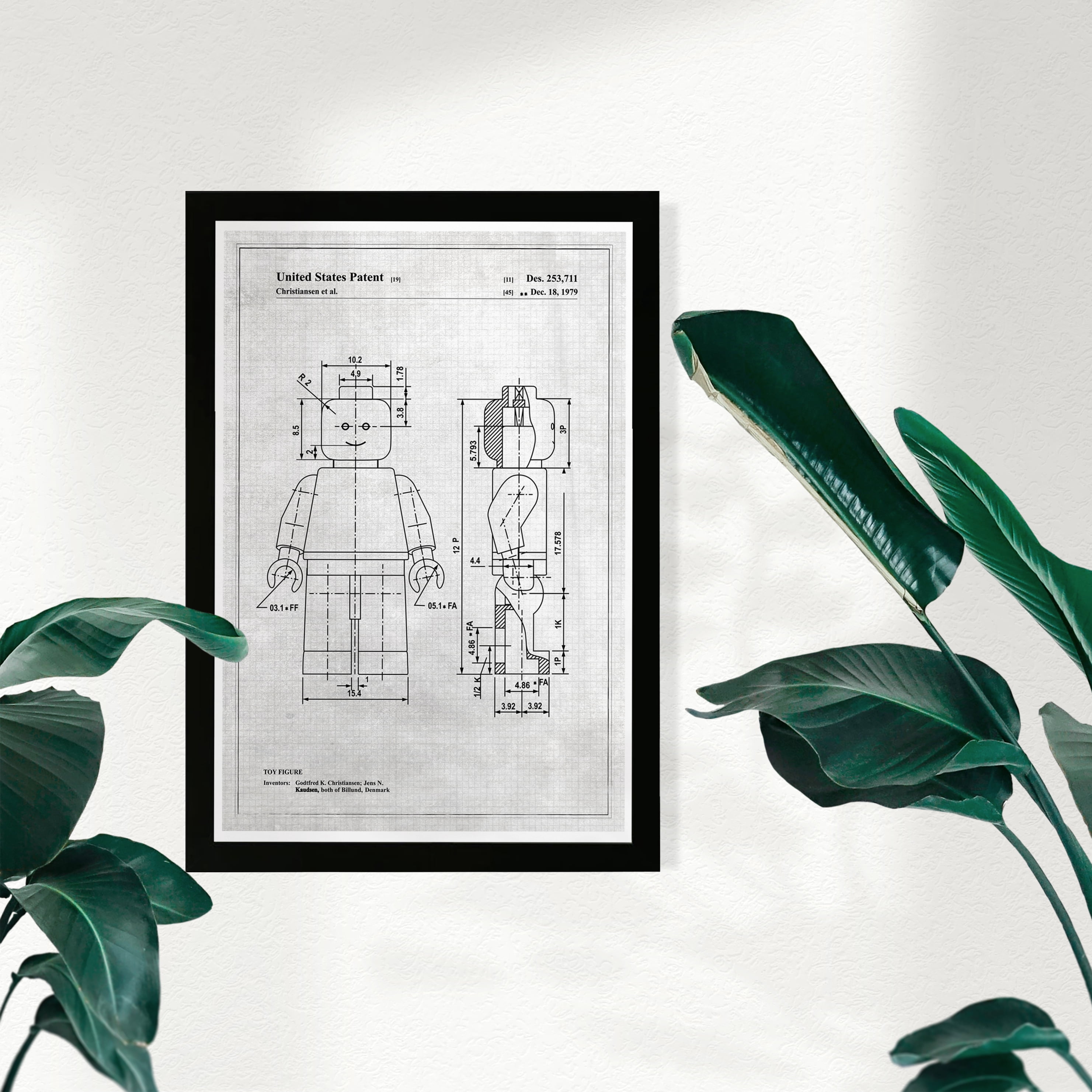 Wynwood Studio Symbols and Objects Framed Wall Art Prints 'Lego Toy Figure, 1979 - Gray' Toys Home Décor - Black, White, 13" x 19"