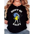 thumbnail image 1 of T-Shirt pour Femmes, "DON T BE SALTY. Fille en Robe Jaune Tenant un Parapluie sous la Pluie", Mode Rétro Minimaliste, Col Rond, Confort Décontracté, T-Shirt à Manches Courtes de Sport, Tee-Shirt de Sport Décontracté, 1 of 7