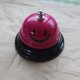 thumbnail image 1 of Campana de mano con forma de cara sonriente de metal para entrenamiento de mascotas, barra de servicio para restaurante, campana de convocatoria, contestador automático de competición, mesa, 1 of 6