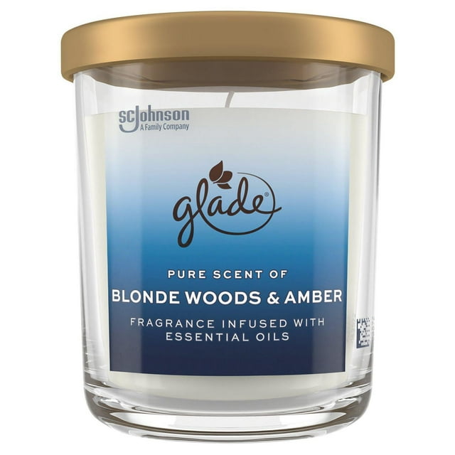 Glade large scented candle in a clear glass jar with beige lid, labeled Blonde Woods & Amber fragrance infused with essential oils.