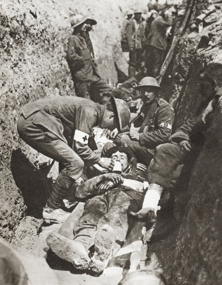 Stretcher Bearers Giving Aid To A Soldier Lying Wounded In A Trench On