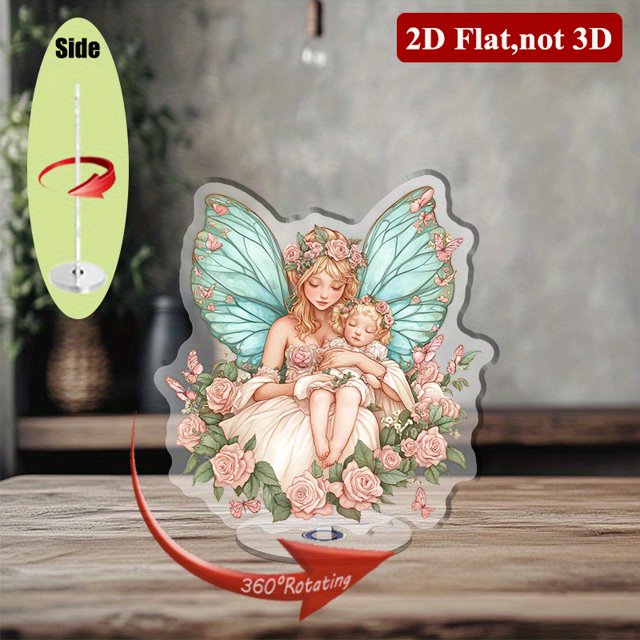 A rotating acrylic display features a fairy with wings and a baby, surrounded by pink roses and a blue butterfly, all against a white background
