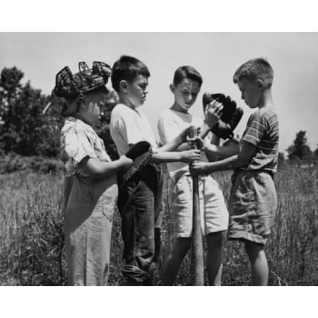 Four youth league baseball players standing in a field Stretched Canvas -  (24 x