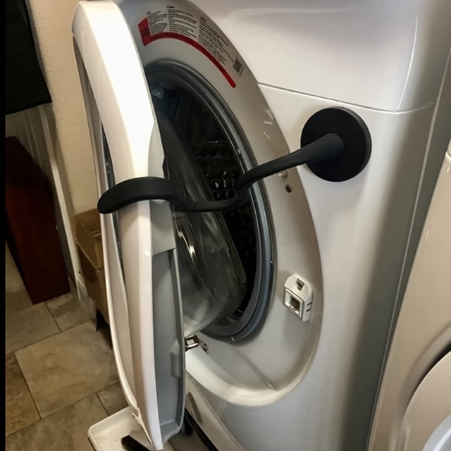 CNKOO Magnetic Front Load Washer Door Prop, an aluminum flexible holder designed to keep washing machine doors slightly open for ventilation. This washer accessory is shown attached to a white front-load washer, fitting securely to the door and frame. Suitable for most models.