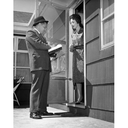 Young woman standing in a doorway and talking to a door to door salesman Canvas Art -  (18 x