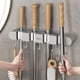 thumbnail image 1 of Soporte multifuncional para trapeadores y escobas Punch | Estante de pared sin taladro para baño, cocina y garaje | Colgador adhesivo para escobas, trapeadores y herramientas, 1 of 7