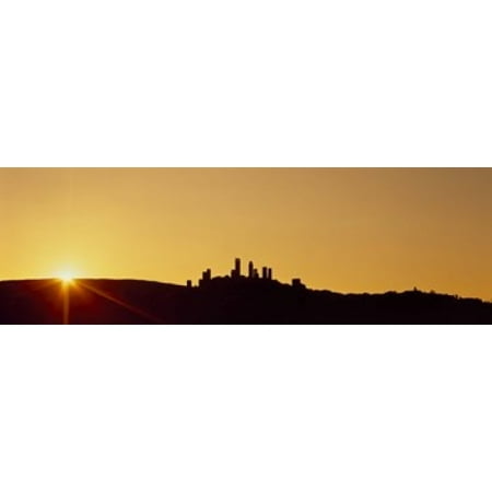 Silhouette of a town on a hill at sunset San Gimignano Tuscany Italy Poster