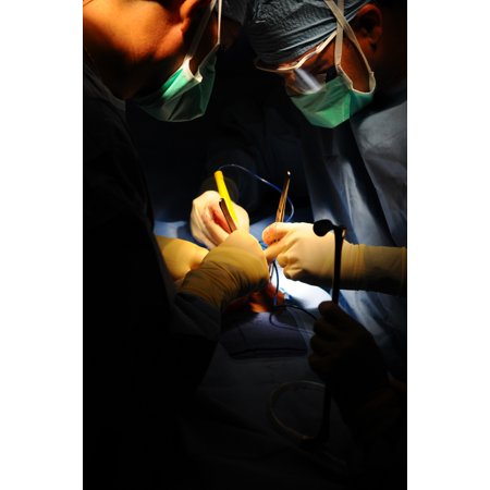 Canvas Print Eliecer Cruz Alvarez, right, a general surgeon from the Dominican National Police performs a hernia Stretched Canvas 10 x