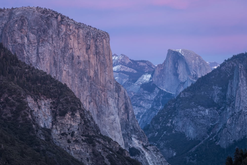 Shades of pink and lavender are reflected on El Capitan Half Dome and winter clouds at dusk in Yosemite National Park as seen from Turtleback Dome California United States of America Canvas Art - Trac