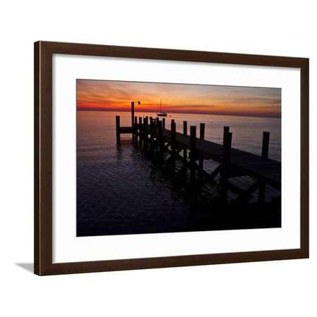 A Single Sailboat Sits on the Water of the Bay Alongside an Empty Dock on Tilghman Island, Maryland Framed Print Wall Art By Karine