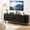 Black, variant on 63 Inch TV Stand with Built-in Power Outlet, Compatible with TVs up to 70 Inches, Designed with Sleek Sliding Doors, a Functional Media console perfect for living rooms, available in a timeless Black