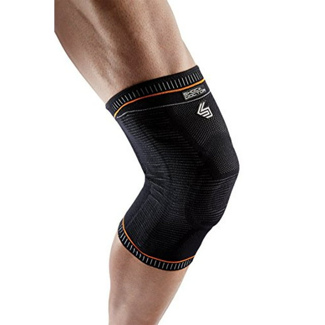 Shock Doctor Ultra Knit Knee Support, a black knee brace for preventing and healing patella instability, meniscus injuries, minor ligament sprains, and hyperextension. Made with breathable knit material for comfort and mobility, featuring orange accents and a snug fit. Suitable for men and women, sold as a single unit.