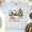 Ash, variant on Small Town House Graphic T-Shirt | Rustic Winter Scene Tee for Men Women Kids, Natural, Size XL