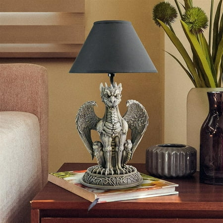 Design Toscano Boden the Gothic Gargoyle Sculptural Table Lamp Illuminate your nights with this dramatic table lamp based on the bestselling Boden Gargoyle  sculpted exclusively for Design Toscano by artist Liam Manchester. Our scaled  collectible Gothic sentinel is sure to impress with its spiny talons  wide wings  menacing teeth and glaring gaze. Atop a base brimming with Celtic detail  this Medieval creature is cast in quality designer resin  then finished in faux stone and fitted with a metal pole rising toward a smart ebony shade. A dragon lovers delight! Accepts your 40-watt bulb. Switch on cord.