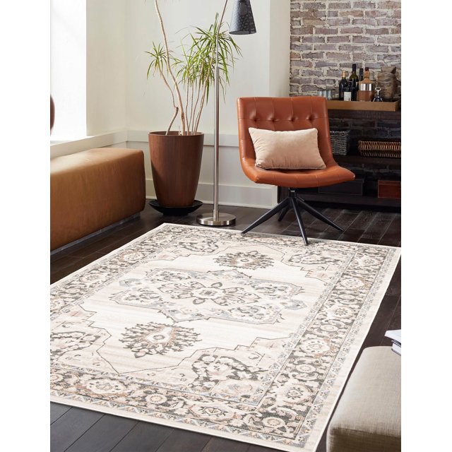 ECARPET Myra traditional area rug featuring intricate floral and geometric designs in beige, gray, and cream tones on dark hardwood flooring with contemporary furniture.