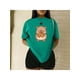 thumbnail image 1 of Playera Blusa De Capybara Comiendo Pretzel Ropa Divertida Para Mujer Capibara Color Verde Talla Chica Marca Emil SaEs, 1 of 4