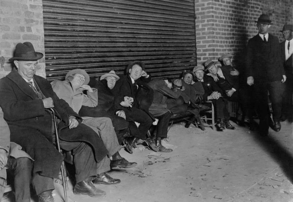 Men In Business Suits Sit And Sleep In Line For Tickets For The Opening