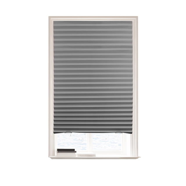 Grey Mainstays cordless pleated paper shade measuring 36 by 72 inches installed over a white-framed window with books on the windowsill.
