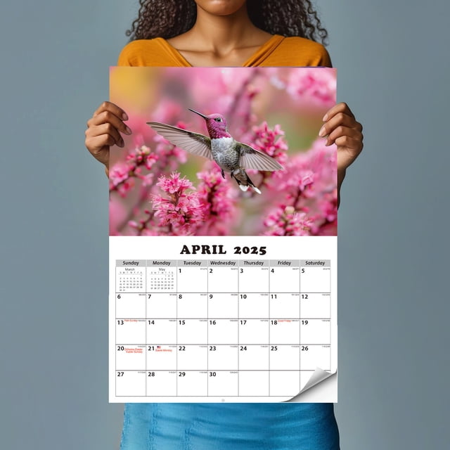 EGNMCR Calendrier Mural Photo d'Oiseaux de Proie Présentant une page d'Avril 2025 avec une image Vivante d'Un Colibri en Vol parmi des Fleurs Roses. Ce Calendrier 16,5 x 11 Pouces Présente de Grandes Cases pour la Planification et la Prise de Notes, Imprimé sur du Papier Certifié avec des Encres à Base de Soya. Idéal comme art Mural Ou Cadeau Attentionné pour la Maison, le Bureau Ou l'École.