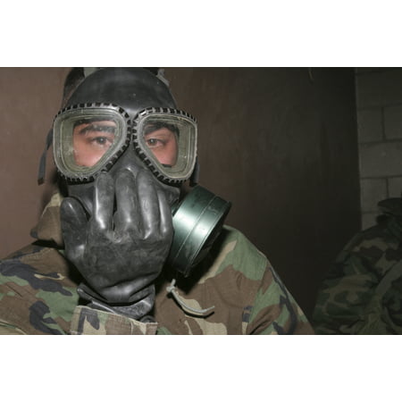 November 22 2005 - A Marine clears his gas mask after he had broken the seal and felt the wrath of the CS gas commonly known as tear gas Poster