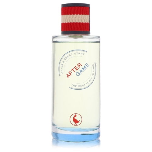 perfume el ganso after game eau de toilette 125 ml para hombre frasco cilíndrico frontal de vidrio transparente con líquido claro, etiqueta circular con 'AFTER GAME' en rojo y azul y logo del ganso en la base; tapa forrada en tela roja con franjas crema; sin caja; también suele usarse como fragancia de viaje por su diseño compacto.