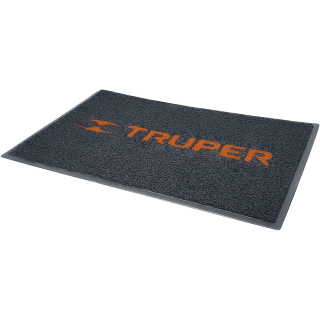 tapete truper Alfombra de entrada 90 x 60 cm, vista 3/4; tapete rectangular de PVC gris oscuro con borde negro y superficie texturizada, logotipo estampado TRUPER en naranja centrado, adecuada para áreas de alto tránsito en hogar o taller.