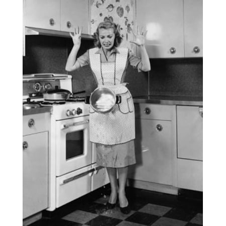 - Young woman dropping a hot pot in front of a stove Poster Print