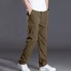 thumbnail image 1 of Pantalones largos de poliéster para hombre, de color liso, informales, con botones, cintura elástica y múltiples bolsillos., 1 of 9