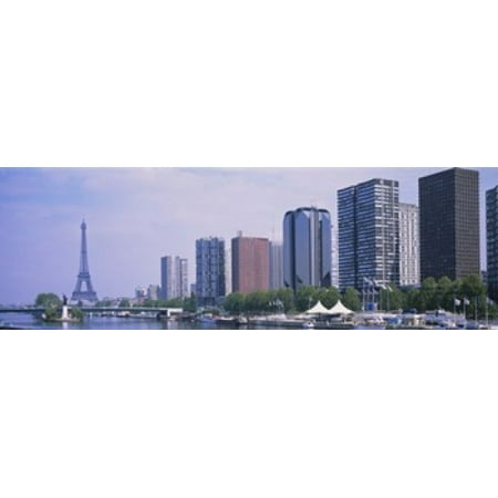 Skyscrapers at the waterfront with a tower in the background Seine River Eiffel Tower Paris Ile-De-France France Canvas Art - Panoramic Images (36 x