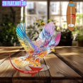 thumbnail image 4 of A rotating acrylic object featuring a vividly detailed winged eagle in colored glass against a white background showcasing rich colors and intricate design, 4 of 6