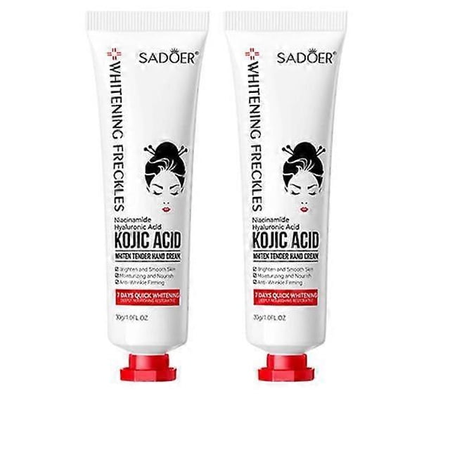 crema de manos, crema blanqueadora de manos con ácido kójico, loción hidratante para manos, cuidado antisequedad para manos, 2 piezas — Dos tubos blancos frontales, vista centrada; cada tubo de 30 g con tapa rosca roja y gráfico de rostro femenino estilizado. Envase indica niacinamida y ácido hialurónico, fórmula no grasa que se absorbe rápido, portátil para bolso; suele usarse también para suavizar áreas secas como codos y cutículas.