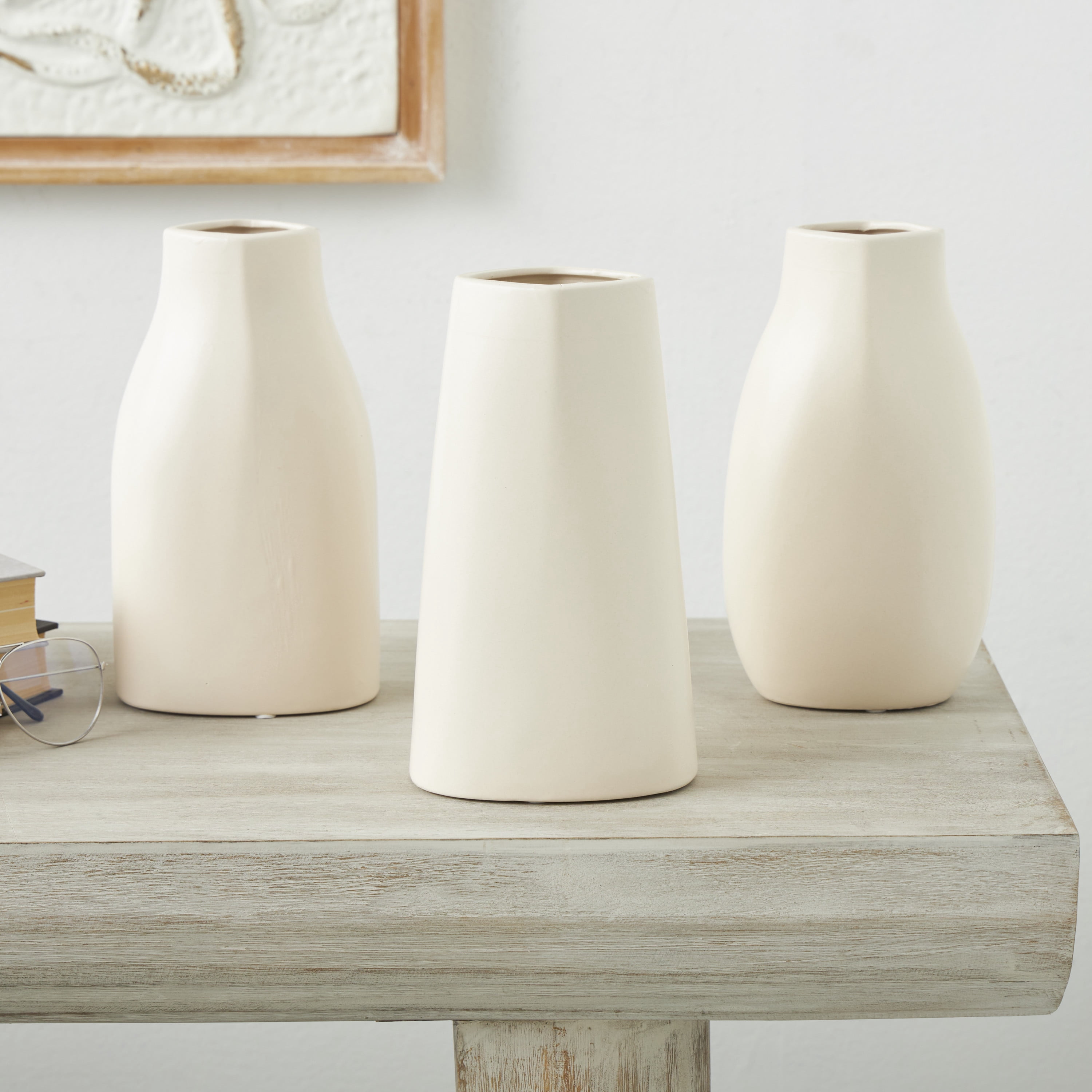 DecMode 5"W, 9"H Minimalistic Dimensional Cream Ceramic Vase with Varying Shapes, Set of 3
