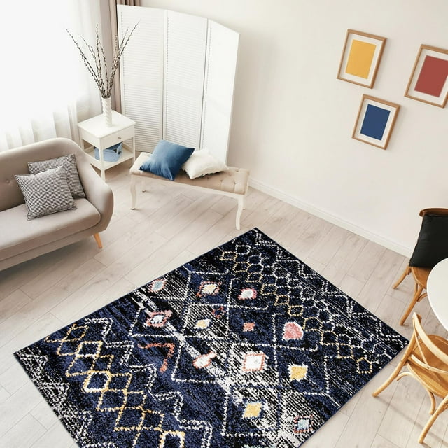 Moroccan style boho chic area rug with colorful geometric designs on navy background placed on light wooden floor in a bright living room.