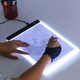 thumbnail image 2 of Mesa de copia LED, tablero de dibujo para niños, mesa de copia transparente, luz nocturna de brillo ajustable, cuaderno, 2 of 5
