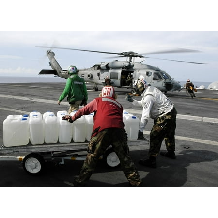 LAMINATED POSTER Sailor's aboard USS Abraham Lincoln (CVN 72) prepare to load jugs of purified water on board an Poster Print 24 x